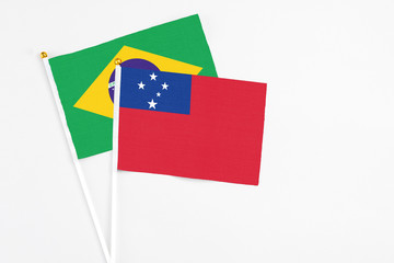 Samoa and Brazil stick flags on white background. High quality fabric, miniature national flag. Peaceful global concept.White floor for copy space.