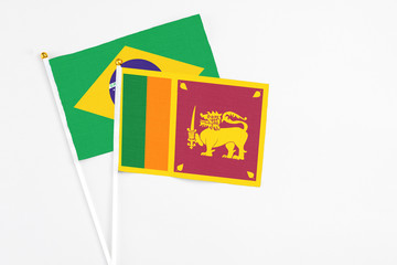 Sri Lanka and Brazil stick flags on white background. High quality fabric, miniature national flag. Peaceful global concept.White floor for copy space.