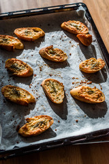 Garlic Parmesan Cheese Bread Slices on Baking Paper Sheet with Oven Tray. Freshly Baked.