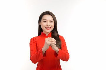 Beauty woman wear red ao dai and feel excited with lunar new year (Tet holiday)
