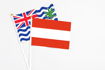 Austria and British Indian Ocean Territory stick flags on white background. High quality fabric, miniature national flag. Peaceful global concept.White floor for copy space.