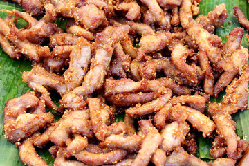 batter-fried pork resting on banana leaf