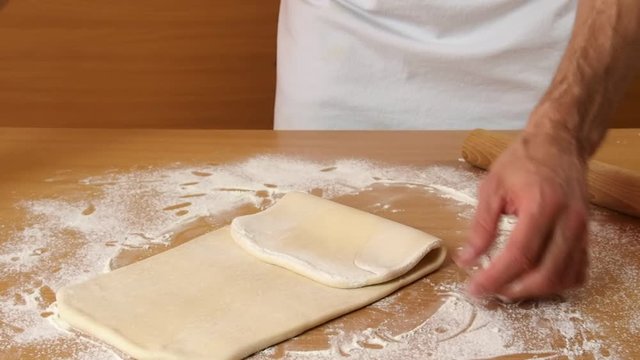 Fold dough and brush off any excess flour. Making Puff Pastry Series.