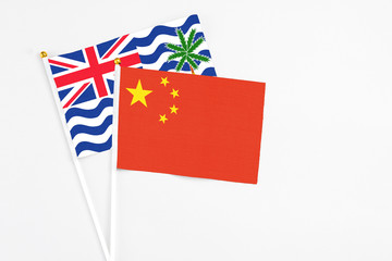 China and British Indian Ocean Territory stick flags on white background. High quality fabric, miniature national flag. Peaceful global concept.White floor for copy space.
