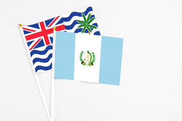 Guatemala and British Indian Ocean Territory stick flags on white background. High quality fabric, miniature national flag. Peaceful global concept.White floor for copy space.
