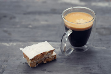 turron and cup of coffee on ceramic background