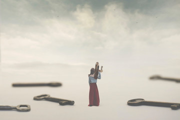 surreal image of a woman choosing a key among many. Concept of solution, choice, probability;...