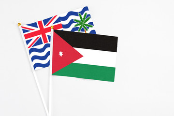 Jordan and British Indian Ocean Territory stick flags on white background. High quality fabric, miniature national flag. Peaceful global concept.White floor for copy space.