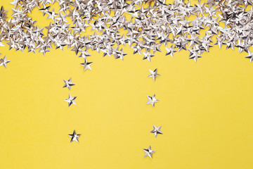 small golden stars on yellow  background