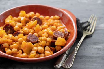 chick pea with sweet potato and smoked sausage on ceramic dish