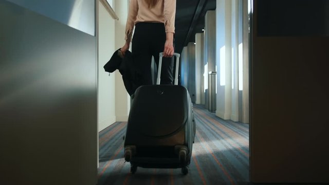 Businesswoman With Travel Suitcase Walking At Hotel Corridor