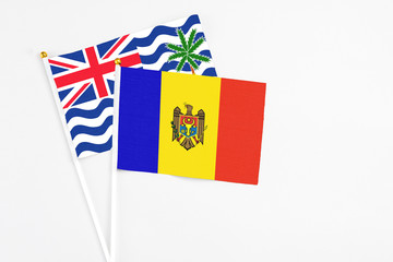 Moldova and British Indian Ocean Territory stick flags on white background. High quality fabric, miniature national flag. Peaceful global concept.White floor for copy space.