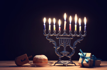 religion image of jewish holiday Hanukkah background with menorah (traditional candelabra), spinning top and doughnut