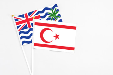Northern Cyprus and British Indian Ocean Territory stick flags on white background. High quality fabric, miniature national flag. Peaceful global concept.White floor for copy space.