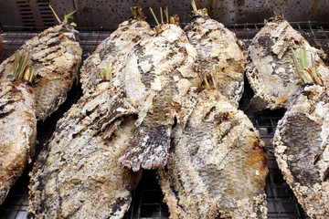 Thai salt-crusted grilled fish on the grill