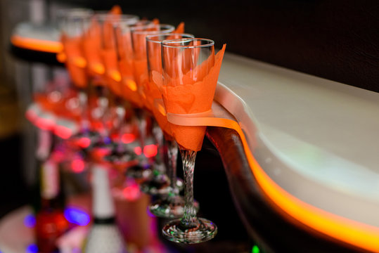 Glasses for champagne and wines in a special holder with lighting inside the limousine