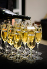 Waiter pours champagne into the glasses
