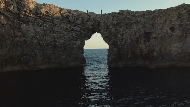 Aproach flight to the geological arch rock of Pont den Gil in Menorca.