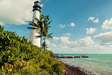 Lighthouse on the ocean among tropical plants. USA, Miami.