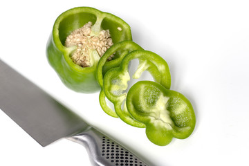 Sliced green bell pepper on white background