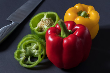 Fresh red green yellow Bell Pepper Slices on darck background
