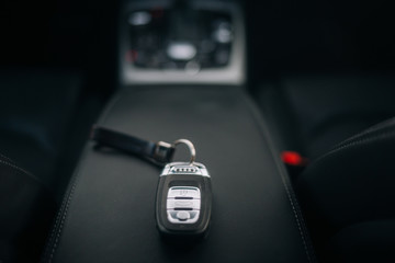 Car ignition key at the armrest