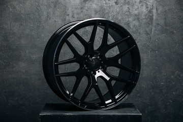 Сar metal disc at the grey background. Car rims isolated in studio 