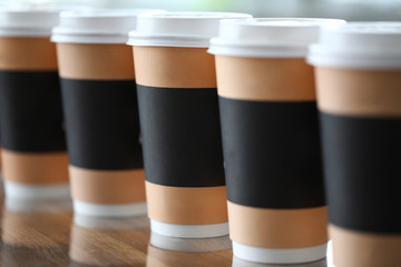 Paper cup line standing at table ready to be taken away