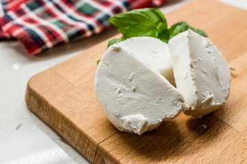 Goat Cheese Slices on Wooden Board. Ready to Eat.
