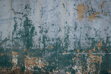 Old and worn out wall background with paint peeling off , Grunge texture of building in a state of disrepair or ruin as a result of age or neglect