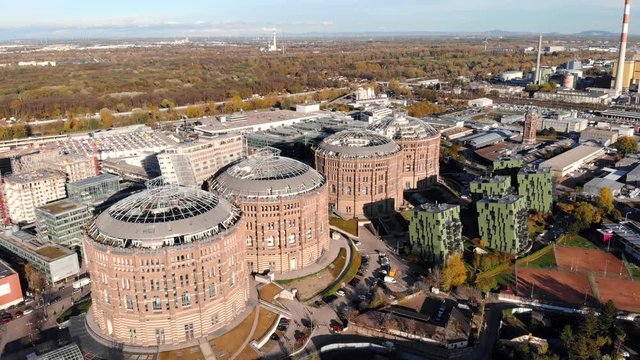 Aerial drone shot of Old Gasometer buidlings in Vienna from up above. Used like gasholders, it is music hall, museum, dormitory and shopping center howadays