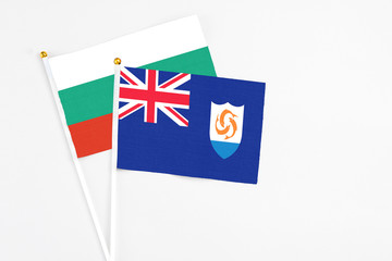 Anguilla and Bulgaria stick flags on white background. High quality fabric, miniature national flag. Peaceful global concept.White floor for copy space.