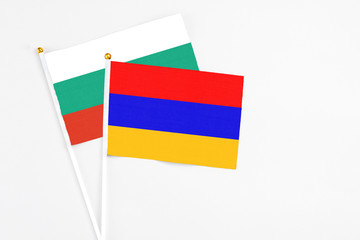 Armenia and Bulgaria stick flags on white background. High quality fabric, miniature national flag. Peaceful global concept.White floor for copy space.