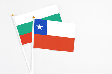 Chile and Bulgaria stick flags on white background. High quality fabric, miniature national flag. Peaceful global concept.White floor for copy space.