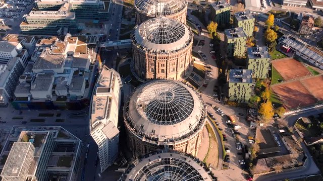 Aerial drone shot of Old Gasometer buidlings in Vienna from up above. Used like gasholders, it is music hall, museum, dormitory and shopping center howadays