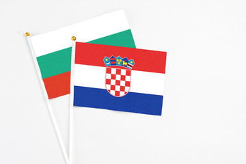 Croatia and Bulgaria stick flags on white background. High quality fabric, miniature national flag. Peaceful global concept.White floor for copy space.