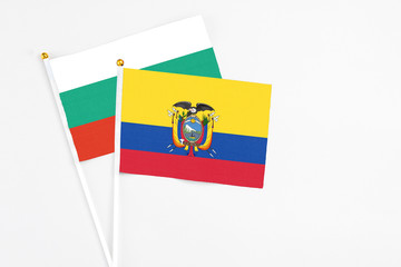 Ecuador and Bulgaria stick flags on white background. High quality fabric, miniature national flag. Peaceful global concept.White floor for copy space.