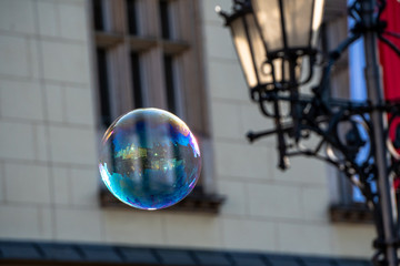 Close up of the colorful soap bubble in the bright autumn day, during independence in Wroclaw,