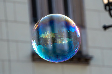 Close up of the colorful soap bubble in the bright autumn day, during independence in Wroclaw,