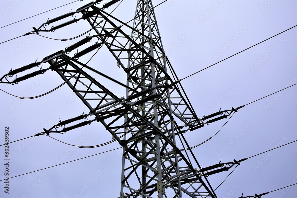 Wall mural high voltage power lines on background of blue sky