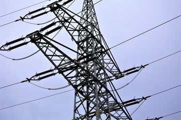 high voltage power lines on background of blue sky