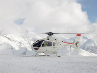 Rescue helicopter on a ski slope in the Alps, France