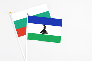 Lesotho and Bulgaria stick flags on white background. High quality fabric, miniature national flag. Peaceful global concept.White floor for copy space.