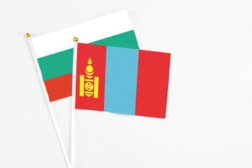 Mongolia and Bulgaria stick flags on white background. High quality fabric, miniature national flag. Peaceful global concept.White floor for copy space.