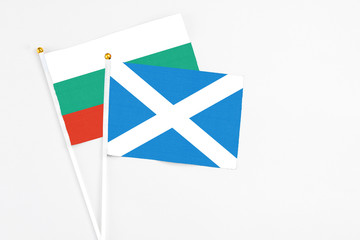 Scotland and Bulgaria stick flags on white background. High quality fabric, miniature national flag. Peaceful global concept.White floor for copy space.