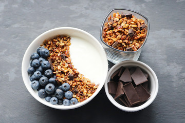 Bowl of homemade granola with yogurt and fresh berries