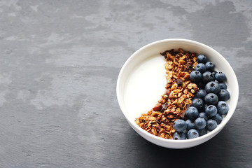 Bowl of homemade granola with yogurt and fresh berries
