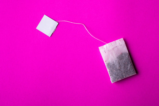 Tea bag on isolated pink background for advertising