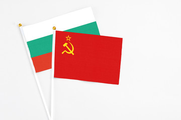 Soviet Union and Bulgaria stick flags on white background. High quality fabric, miniature national flag. Peaceful global concept.White floor for copy space.