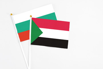 Sudan and Bulgaria stick flags on white background. High quality fabric, miniature national flag....